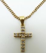 A yellow metal cross set with diamonds set with 11 round cut diamonds on a 9ct gold chain, 13.5g