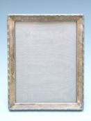 George V hallmarked silver photograph frame with decorated border and easel back to suit 8 x 6