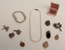 A single stand of cultured pearls, a silver curb link bracelet, two silver heart lockets, a