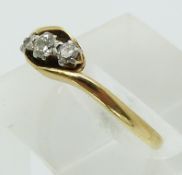 An 18ct gold ring set with three diamonds in a platinum setting (size N)