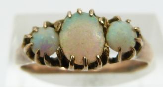 A 9ct gold ring set with three opal cabochons (size L)