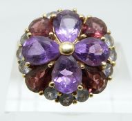 A 14k gold ring set with amethysts and garnets in large cluster (size L)