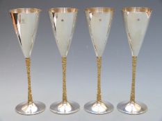 Stuart Devlin set of four modern hallmarked silver champagne flutes with retro bark effect stems,