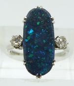 A platinum ring set with a black opal of approximately 2.39ct and two round cut diamonds, each