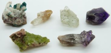 An amethyst crystal with tourmaline inclusions, another amethyst crystal, a quartz crystal, an