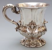 William IV hallmarked silver tankard or mug with embossed floral decoration and fluted body,