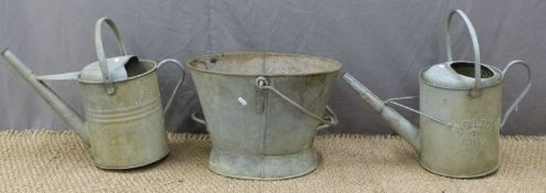 Two ministry marked galvanised watering cans and a bucket