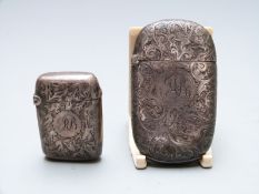 Two Victorian hallmarked silver vesta cases, both with engarved decoration, one 6cm long and