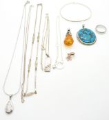 A collection of silver jewellery including a turquoise pendant, pressed amber pendant, diamond