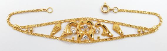 A yellow metal Eastern bracelet set with cubic zirconia, 4.7g