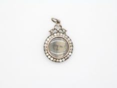 A 19thC locket set with paste and photographs to both sides