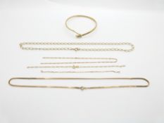 A yellow metal bangle and two 9ct gold necklaces, 15.8g