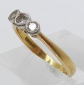 An 18ct gold ring set with three diamonds in a platinum setting (size N)