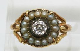 An early Victorian ring set with an old cut diamond of approximately 0.35ct surrounded by seed