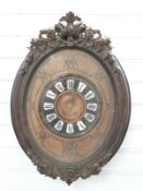 French vineyard clock in carved decorated case, with Roman cabochon numerals, pierced brass hands