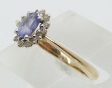 A 9ct gold ring set with a tanzanite and diamonds (size P)