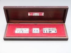 Three cased silver ingots depicting the three Royal Standards, cased with leaflet, total weight of
