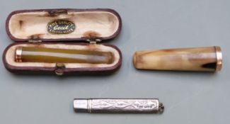 A cheroot holder with a 9ct gold mount, a bone cheroot holder with a yellow metal mount and a