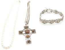 A silver bracelet set with paste, a cultured pearl necklace and a silver cross set with agate