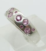 A 9ct gold ring set with round cut pink sapphires (size P)