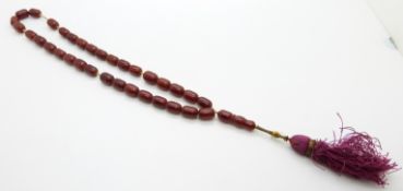 A set of 19thC prayer beads, possibly cherry amber, the largest bead 10x14mm,  40g