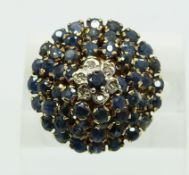 A 9ct gold ring set with sapphires and diamonds in a large cluster (size O)