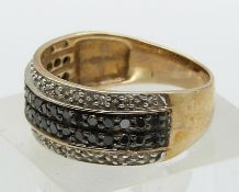 A 9ct gold ring set with black and clear diamonds (size O)