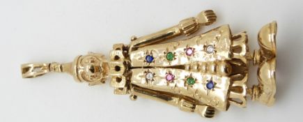 A 9ct gold pendant depicting a clown with moving arms and legs set with rubies, emeralds, cubic