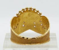 A yellow metal Indian ring set with cubic zirconia, 3.2g (size R)