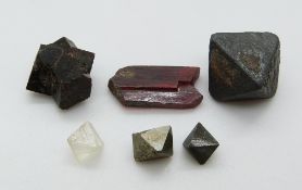 A rough uncut fluorite crystal, a pyrite crystal and other crystals