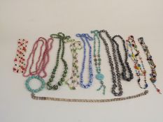 A collection of necklaces including a silver necklace made up of circular links, pearl, glass, agate