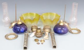 Two oil lamps in pieces with etched yellow glass shades and blue glass bowls