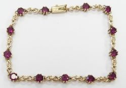 A 9ct gold tennis bracelet set with garnets, 5.8g