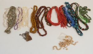 A collection of beaded necklaces including pearls, tiger's eye, glass, shell, coral etc