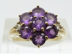 A 9ct gold ring set with amethysts in a cluster (size N)