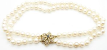 A double strand pearl necklace with 9ct gold clasp set with a sapphire and diamonds, 20.5cm drop