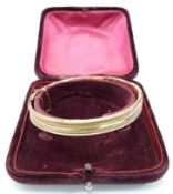 A 9ct rose gold bangle in original box, 8.9g