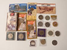 A collection of various crowns and commemorative coins, some in presentation packs