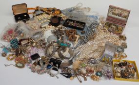 A large collection of costume jewellery including brooches, beads, bracelets, cufflinks, chains,