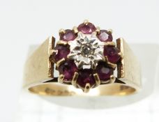 A 9ct gold ring set with rubies and a diamond (size N)