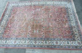 Woollen rug on a pink ground, 365 x 262cm
