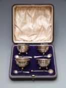 George V cased set of four open salts raised on ball feet, Birmingham 1913 maker T.H.Hazelwood & Co.