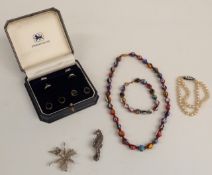 A cased set of silver studs and cufflinks, two silver and marcasite brooches, glass beaded
