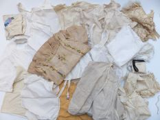 A collection of 19thC childrens and small sized clothing including blouses / shirts, corsets,