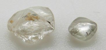 A loose uncut diamond macle, 0.1g and another loose diamond