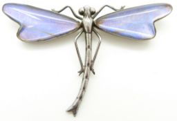 A silver dragonfly brooch set with butterfly wing