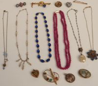 A gold plated heart locket, a gold plated brooch set with hardstone scarab beetles, Victorian