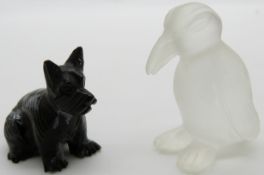An obsidian carved dog and a rock crystal penguin