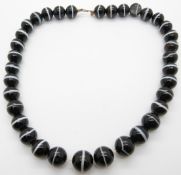 A banded agate necklace made up of 34 round beads
