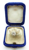 An 18ct gold ring set with a round cut diamond of approximately 1ct in a platinum setting, in